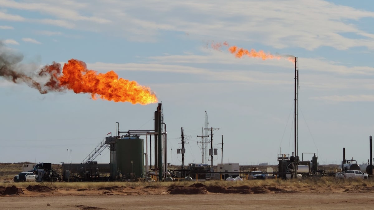 Methane gas flares at an EOG well site in Cotton Place, New Mexico